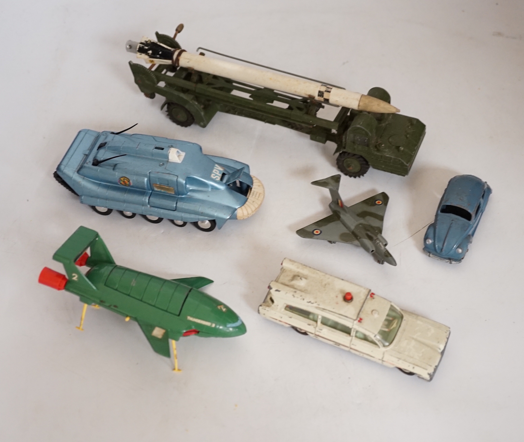 Twenty-two Dinky Toys mostly for restoration, including a Car Carrier (984), Missile Erector, Missile Servicing Platform, Spectrum Pursuit Vehicle, Thunderbird 2 containing Thunderbird 4, Rolls-Royce Silver Wraith, etc.